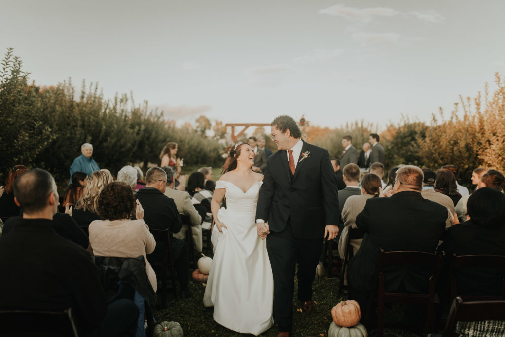 An Intimate wedding ceremony in an apple orchard 