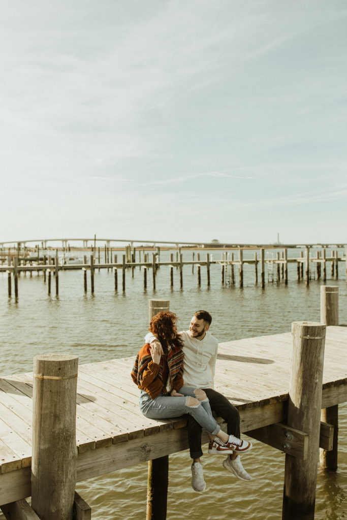 A couples photoshoot on the beach at a dock in ocean city new jersey