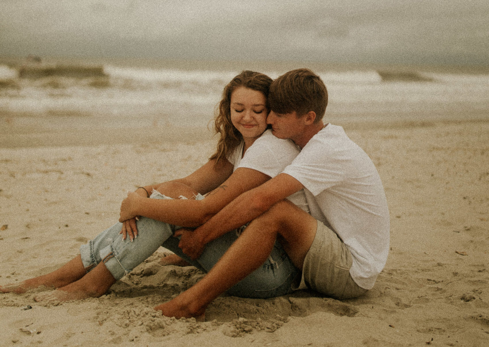 A couple at a florida beach for their engagement photoshoot