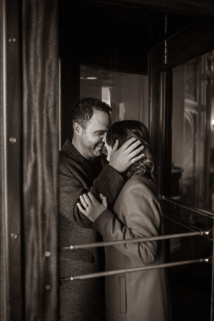 Winter engagement photoshoot in a revolving door in the city