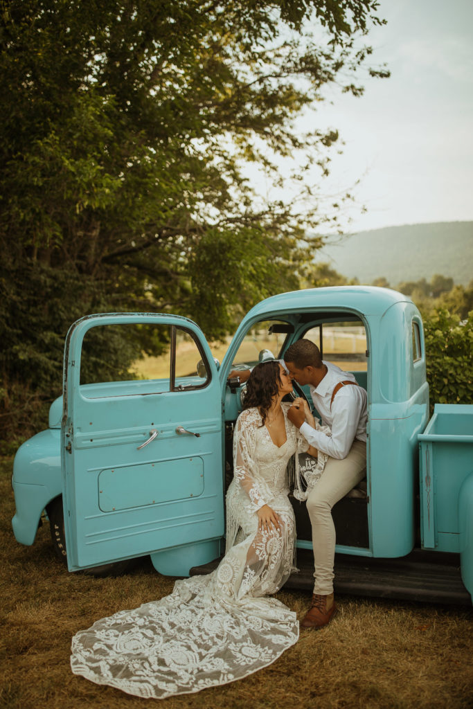 A couple in their getaway car after their central Pennsylvania elopement in the woods