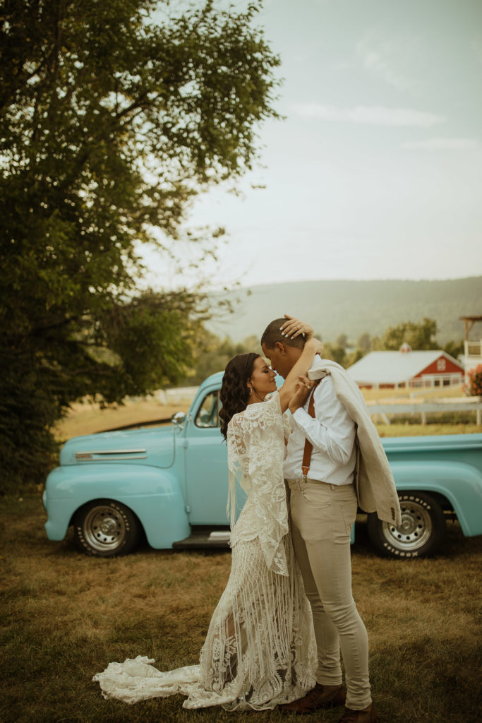 A couple in their getaway car after their central Pennsylvania elopement in the woods
