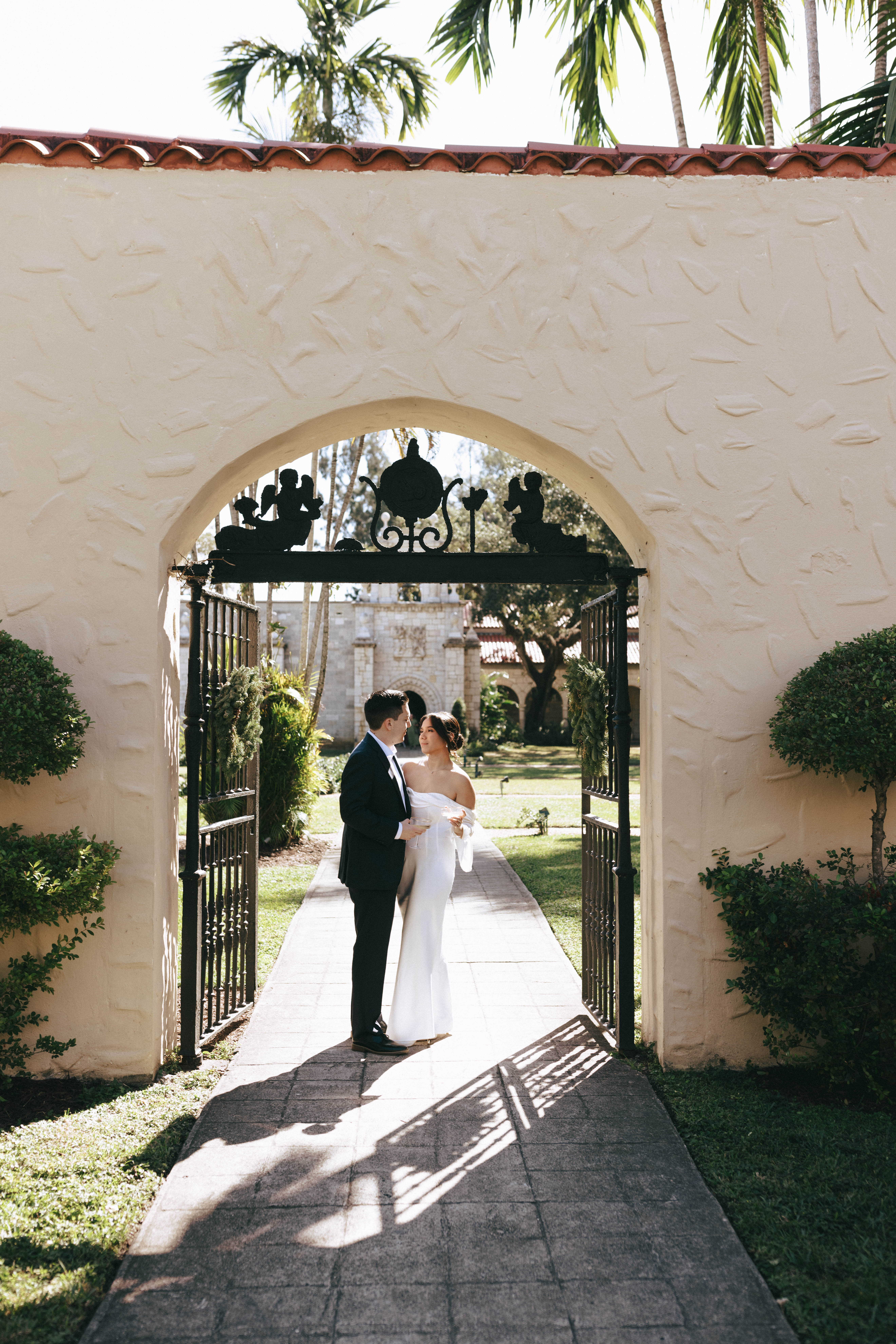 Elegant wedding couple photographed in front of European-style stone walls at The Spanish Monastery.
