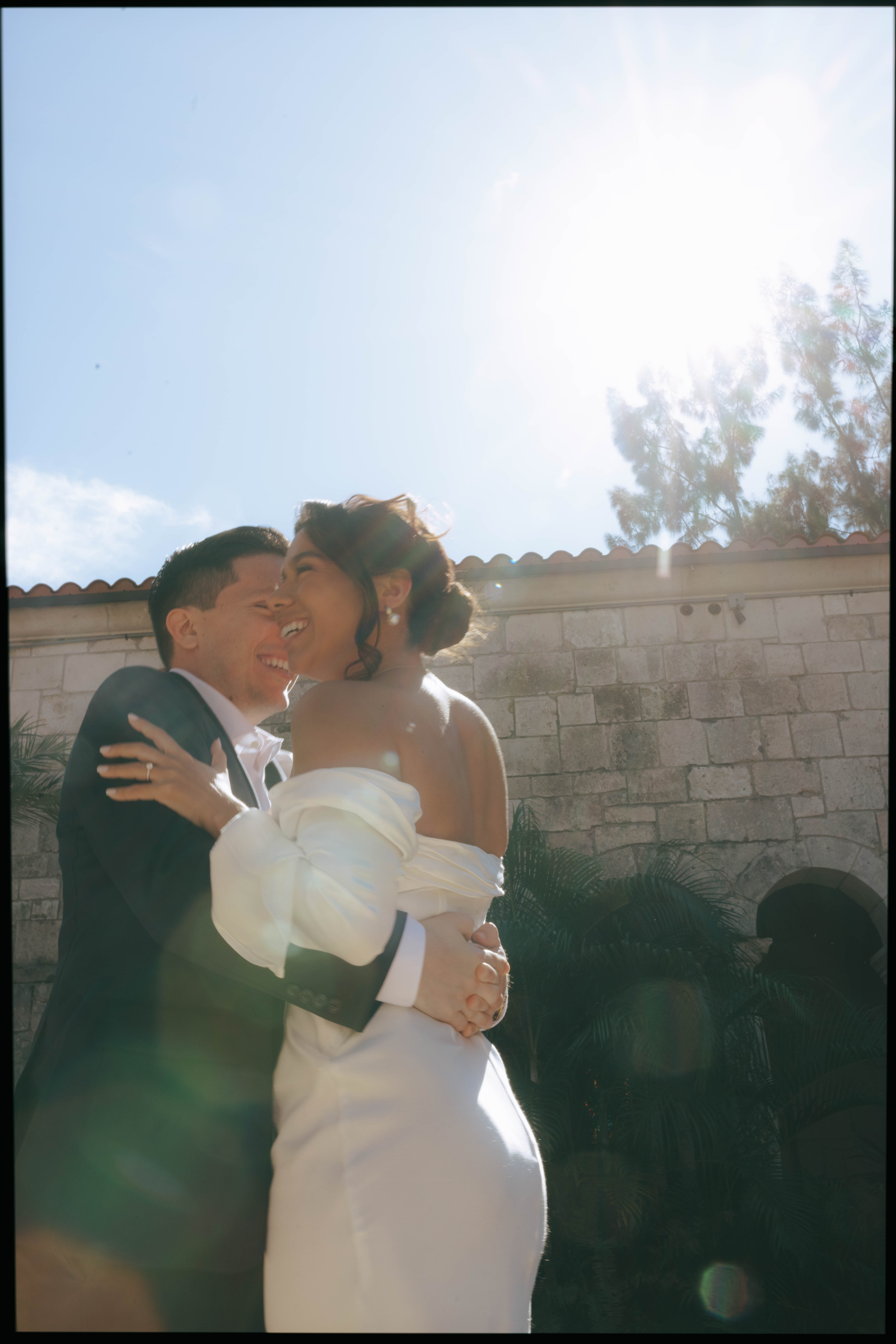 Elegant wedding couple photographed in front of European-style stone walls at The Spanish Monastery.