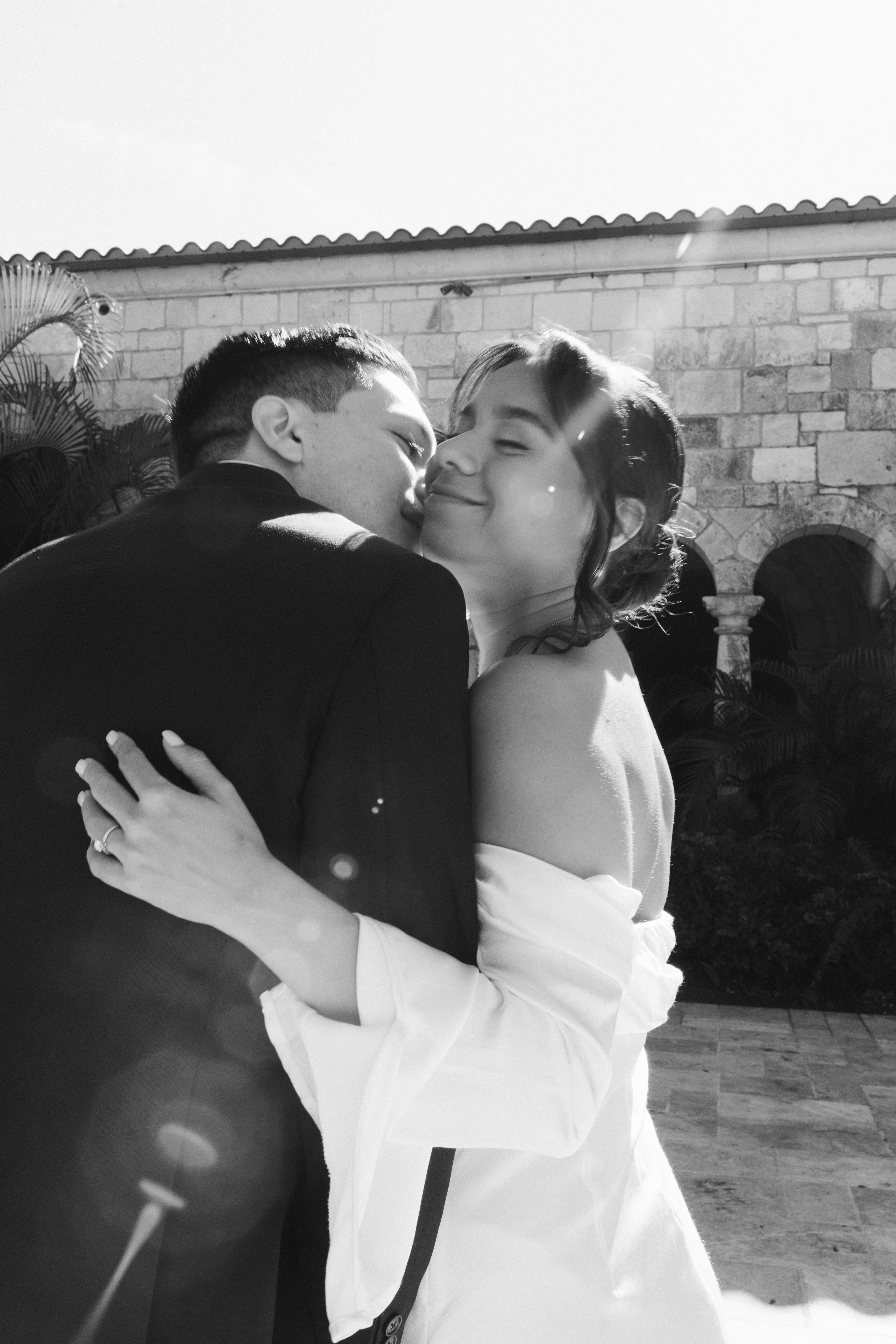Elegant wedding couple photographed in front of European-style stone walls at The Spanish Monastery.