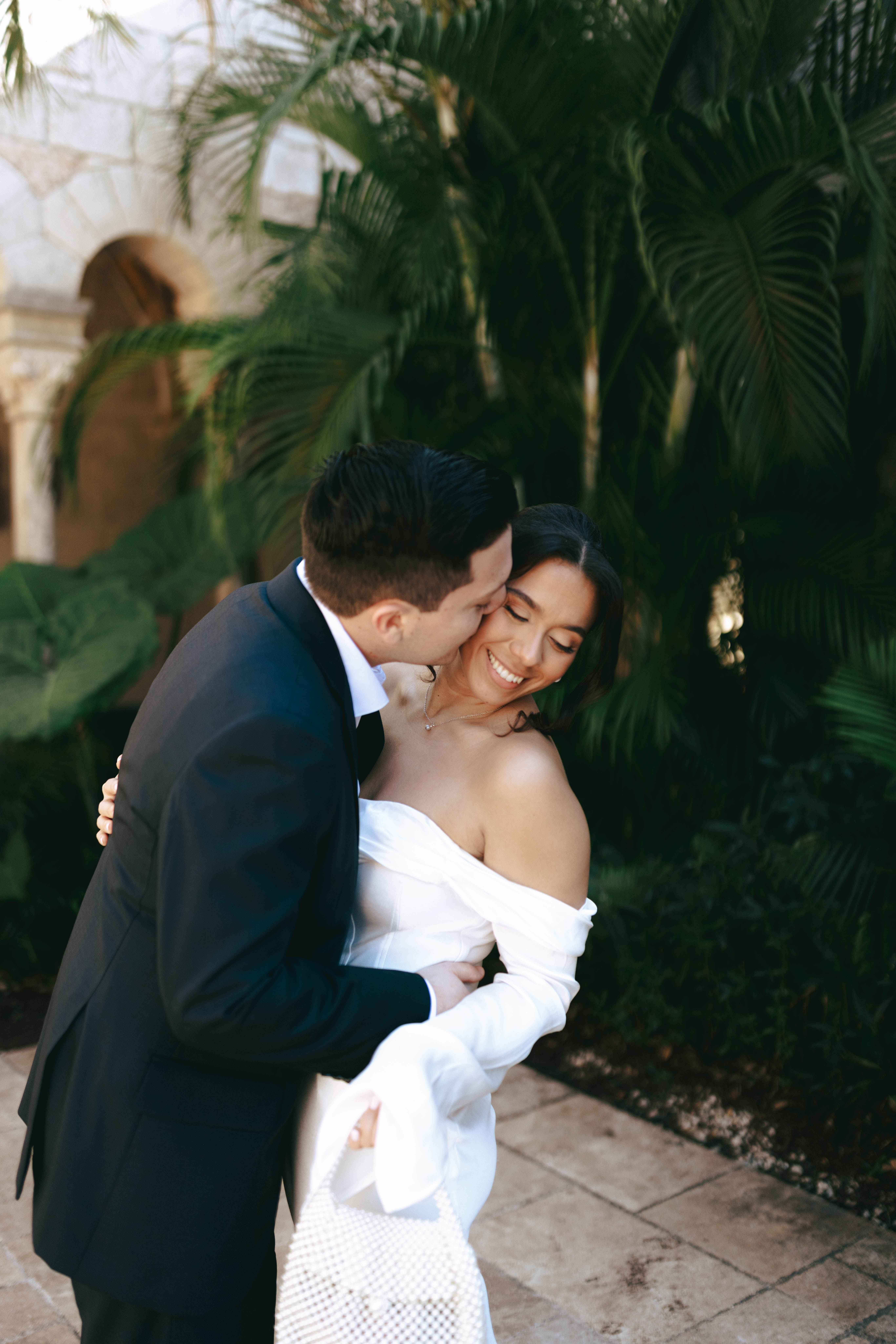 Elegant wedding couple photographed in front of European-style stone walls at The Spanish Monastery.