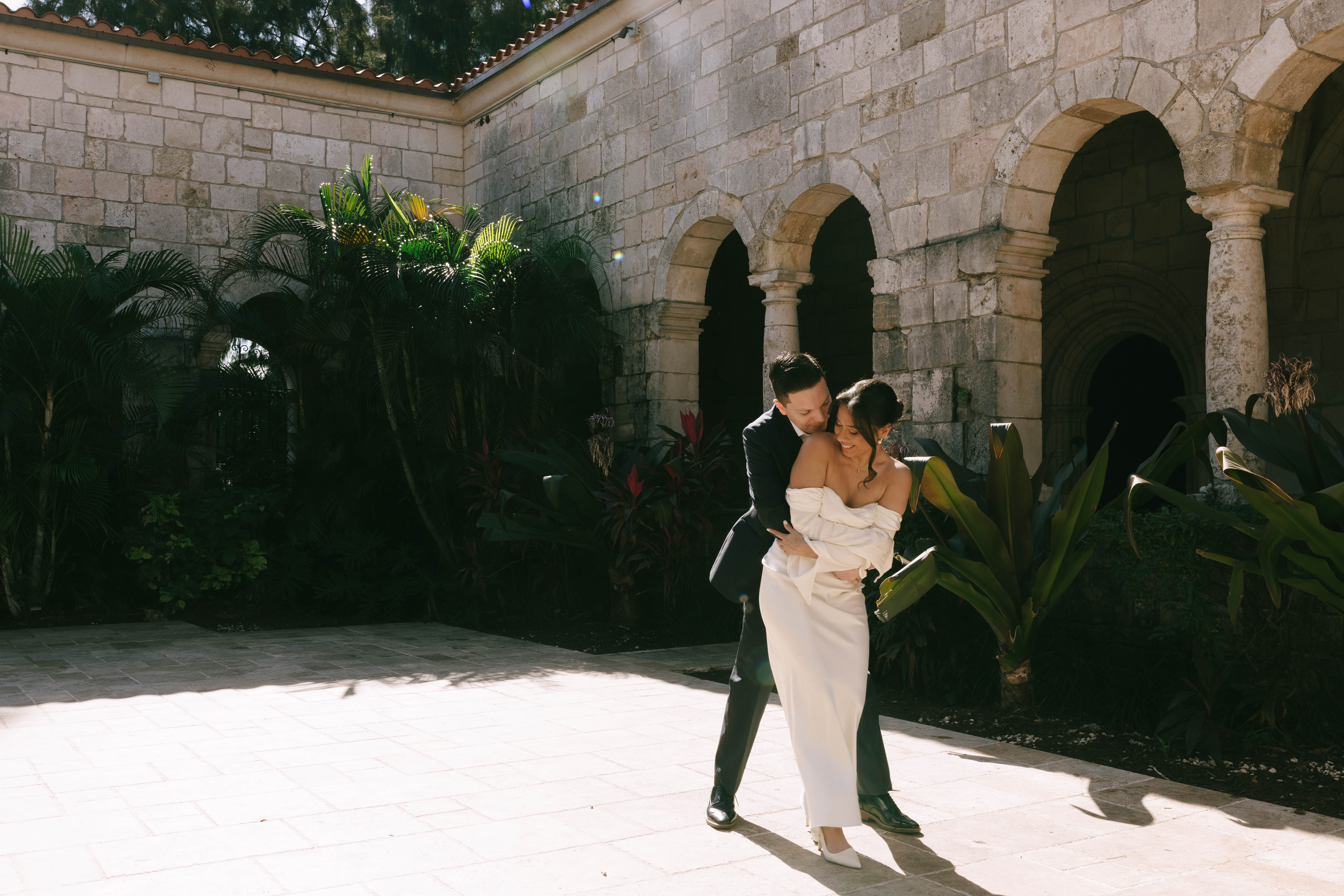 Elegant wedding couple photographed in front of European-style stone walls at The Spanish Monastery.