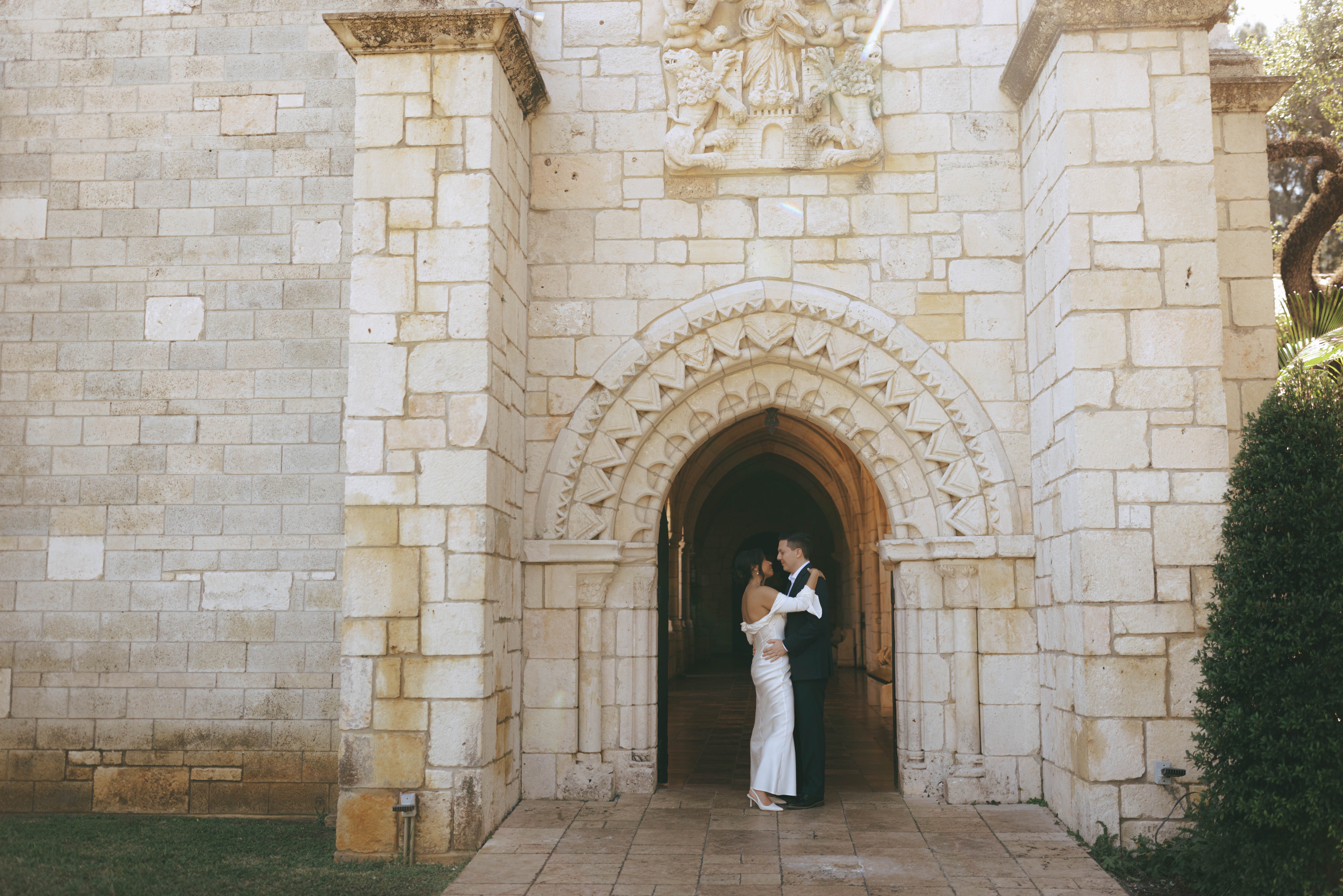 Elegant wedding couple photographed in front of European-style stone walls at The Spanish Monastery.