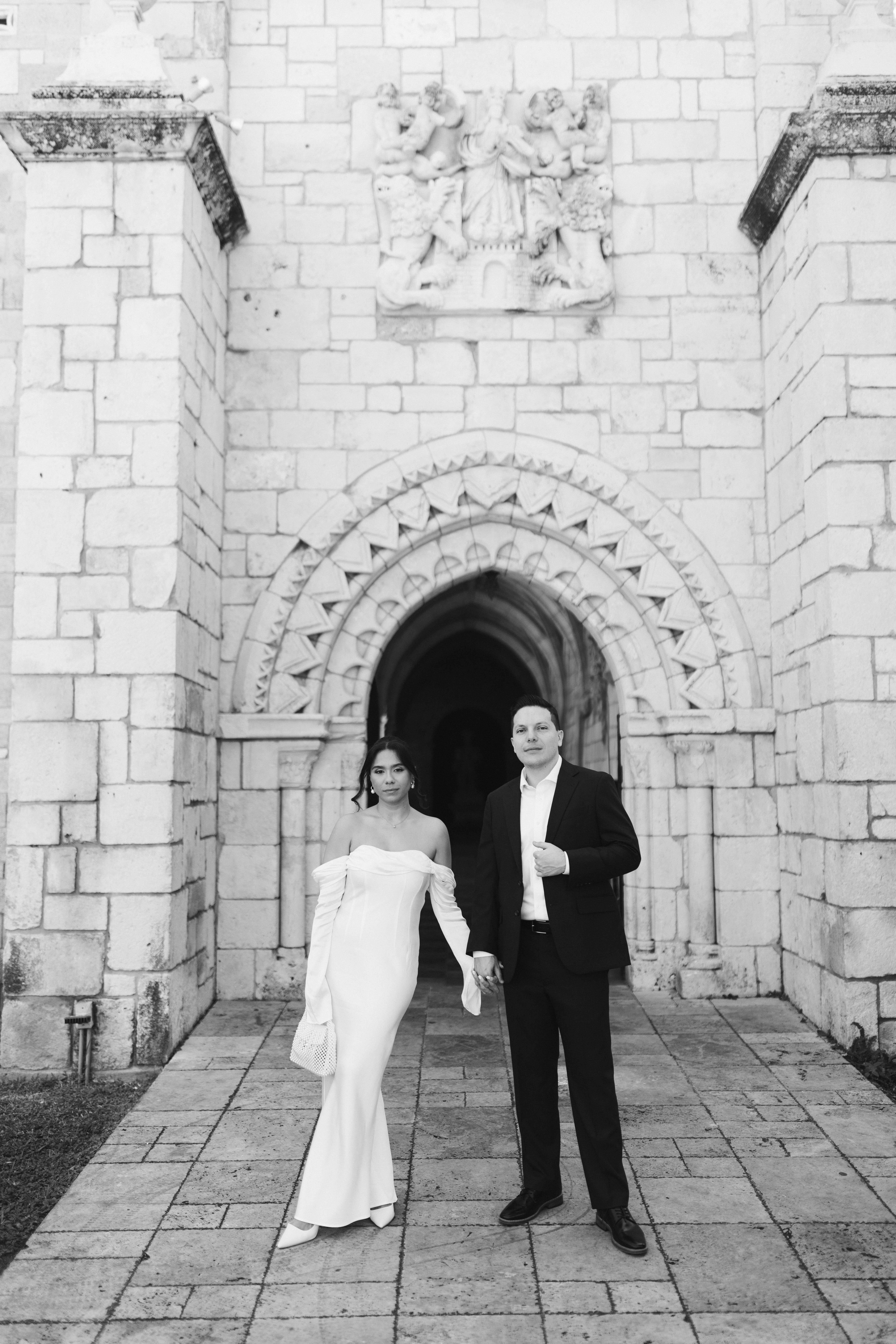Elegant wedding couple photographed in front of European-style stone walls at The Spanish Monastery.