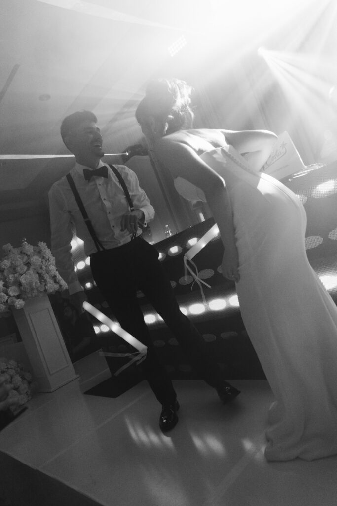 Lively Ritz-Carlton Fort Lauderdale wedding reception with dancing under elegant lighting