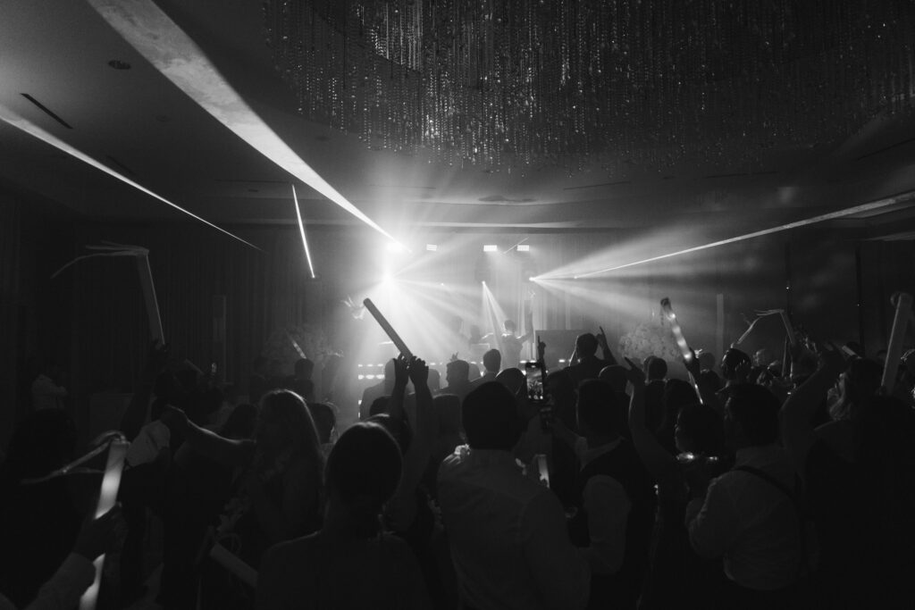 Lively Ritz-Carlton Fort Lauderdale wedding reception with dancing under elegant lighting