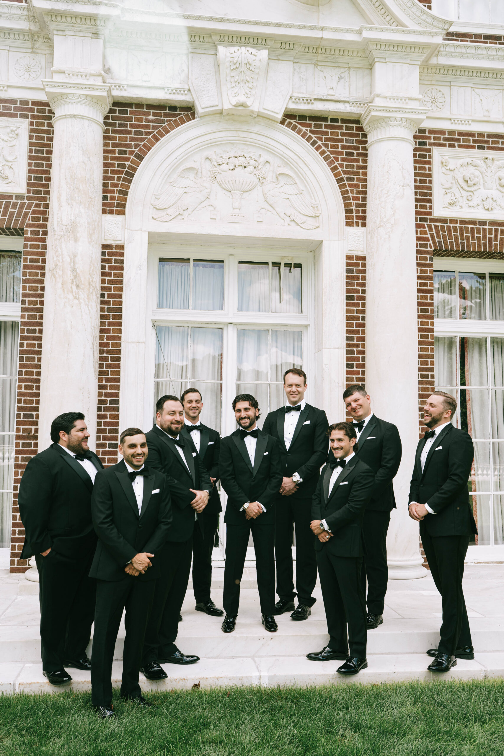 bridal party walking through manicured gardens at Old Westbury estate