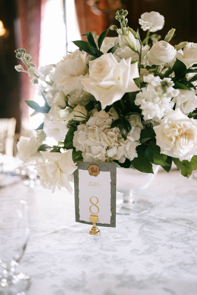 Elegant estate wedding reception with classic floral centerpieces