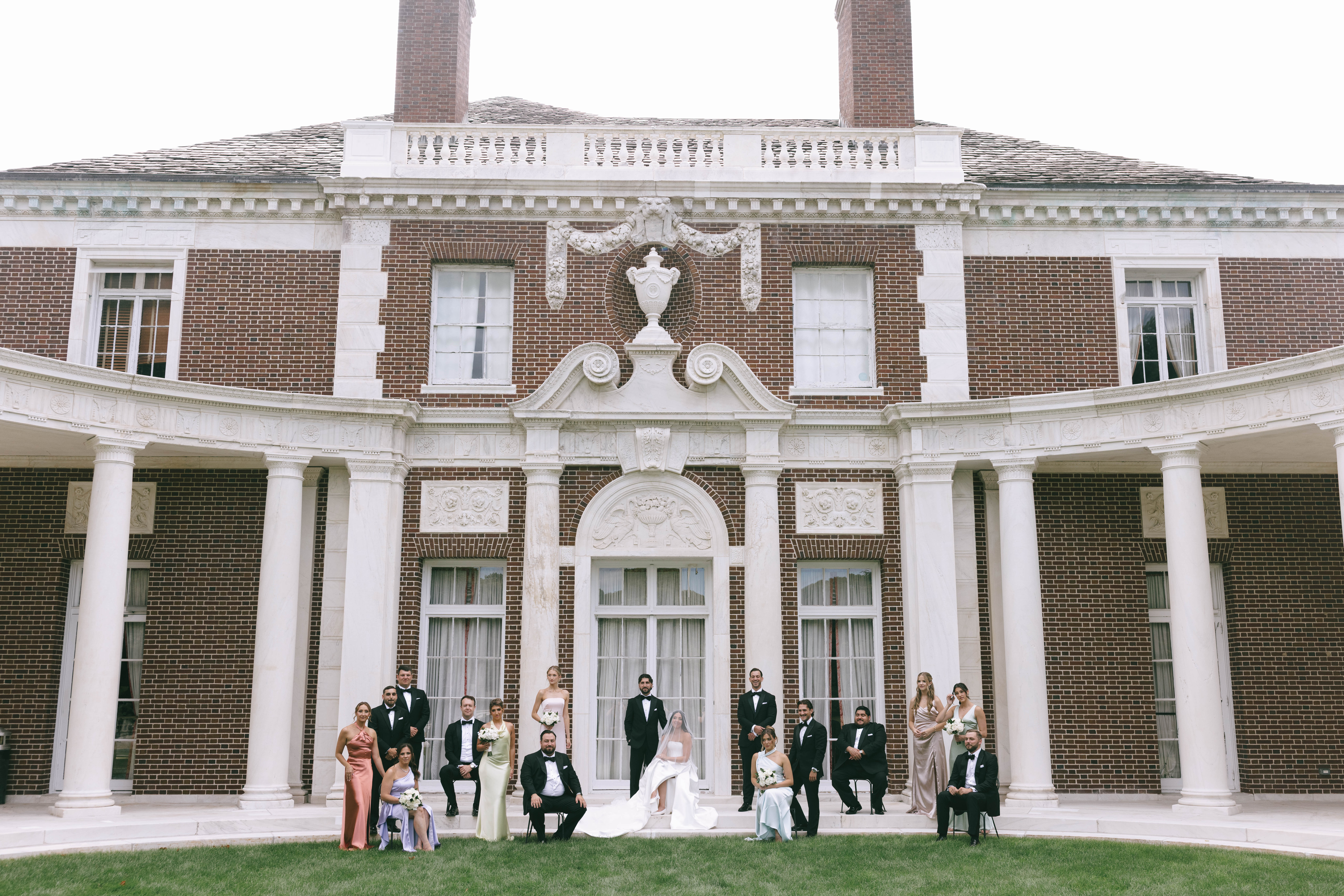 bridal party walking through manicured gardens at Old Westbury estate