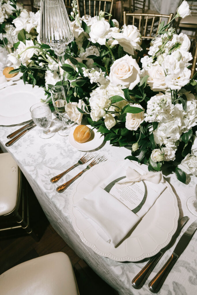 Elegant estate wedding reception with classic floral centerpieces