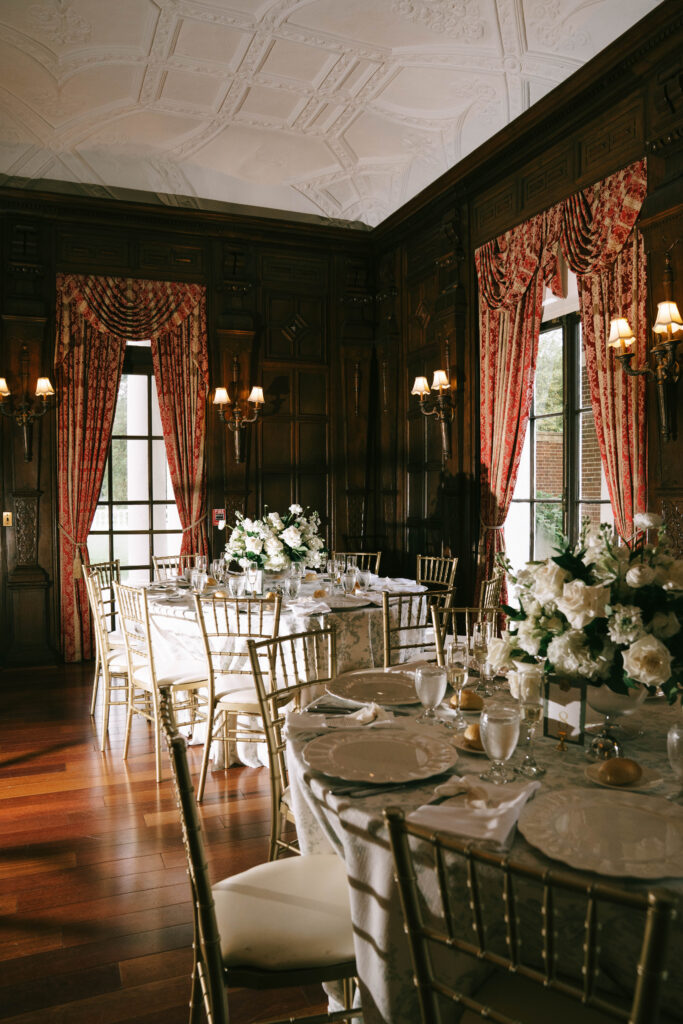 Elegant estate wedding reception with classic floral centerpieces