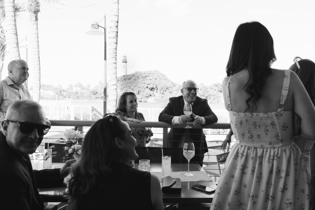 Couples and guests enjoying cocktails at The Beacon welcome party in Jupiter, Florida